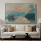 Sunset on the Seine at Lavacourt, Winter Effect, 1880 by Claude Monet displayed in a natural wood floater framed canvas above a sofa in a clean living room.