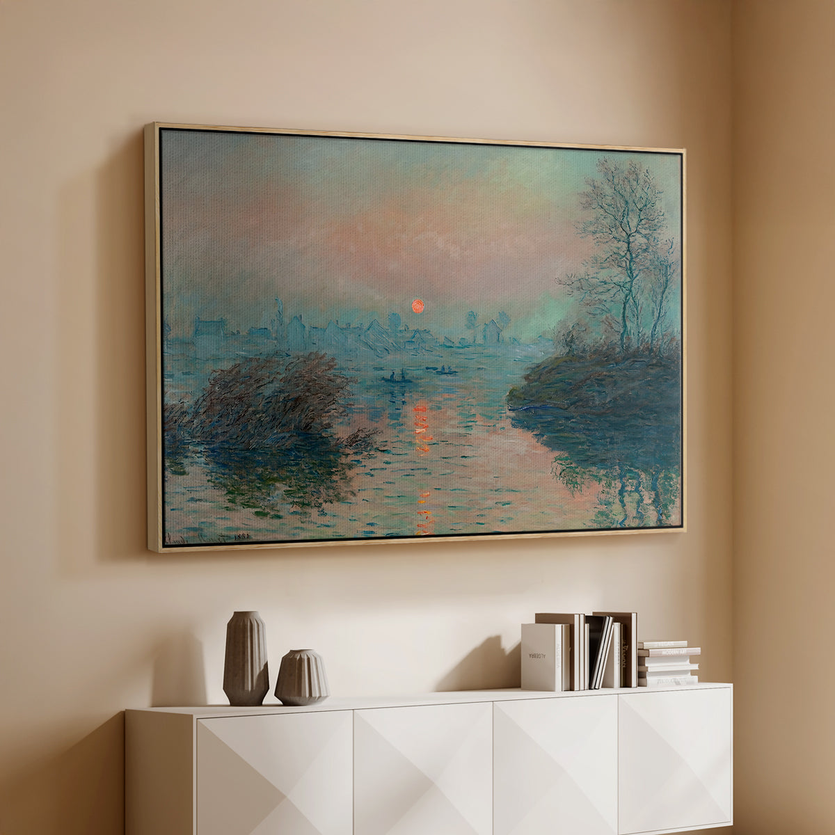 Natural wood floater framed canvas of Sunset on the Seine at Lavacourt, Winter Effect, 1880 by Claude Monet, featuring a winter scene with warm light reflecting on water at dusk above a console cabinet in a minimalist entryway.