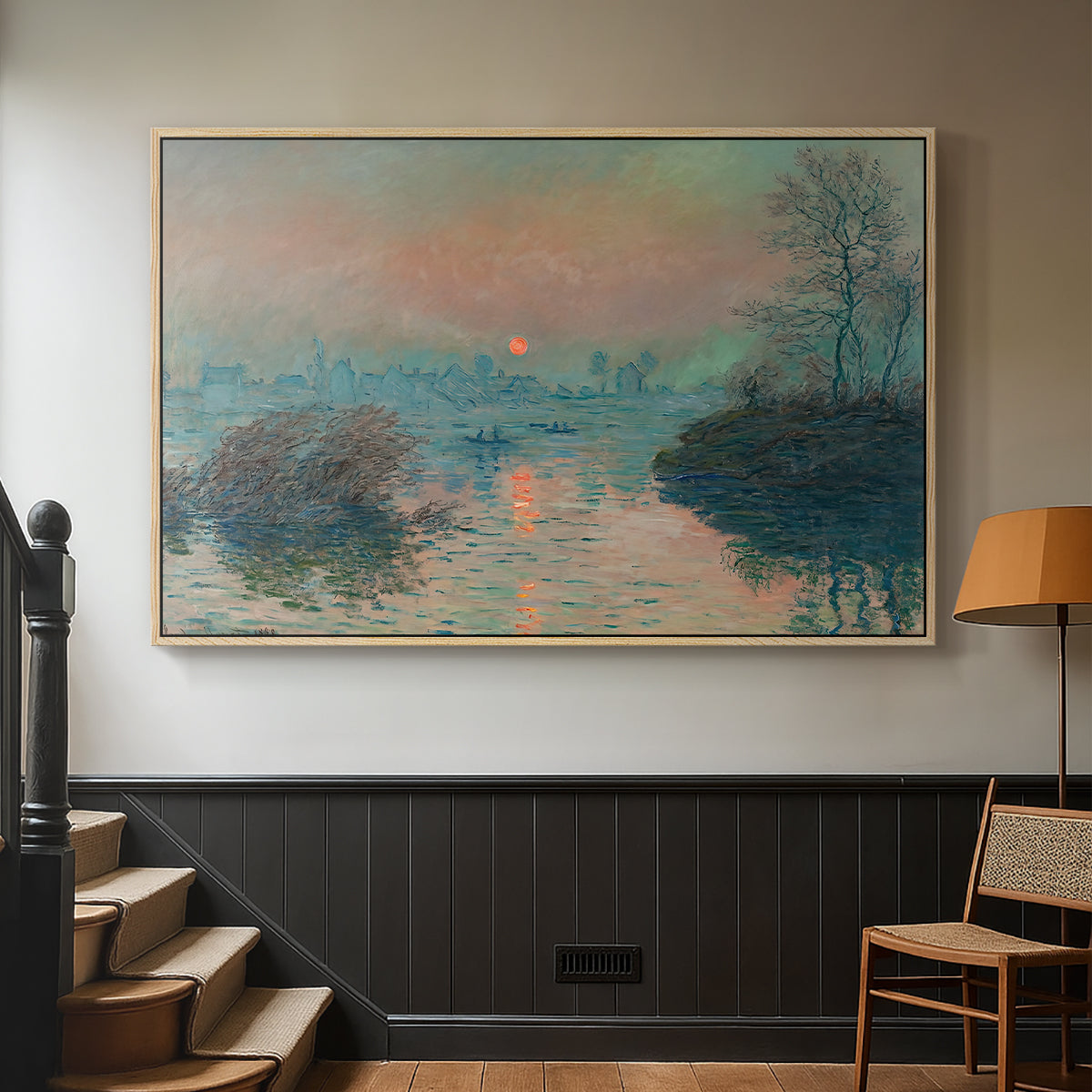 Natural wood floater framed canvas featuring an atmospheric landscape combining cold tones and warm sky, displayed in a hallway near a staircase.
