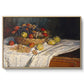 Still Life with Apples and Grapes, 1880 by Claude Monet in a natural wood floater framed canvas wall art display.