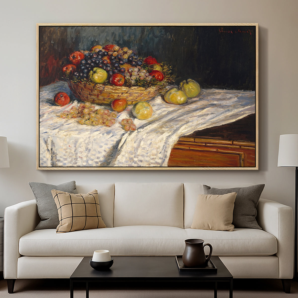 Still Life with Apples and Grapes, 1880 by Claude Monet displayed in a natural wood floater framed canvas above a sofa in a clean living room.
