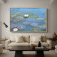 Water Lilies (Nymphéas), 1897-1899 by Claude Monet as a natural wood floater framed canvas featuring floating water lilies on pond with reflections of sky and foliage, displayed above a sofa in a modern living room.