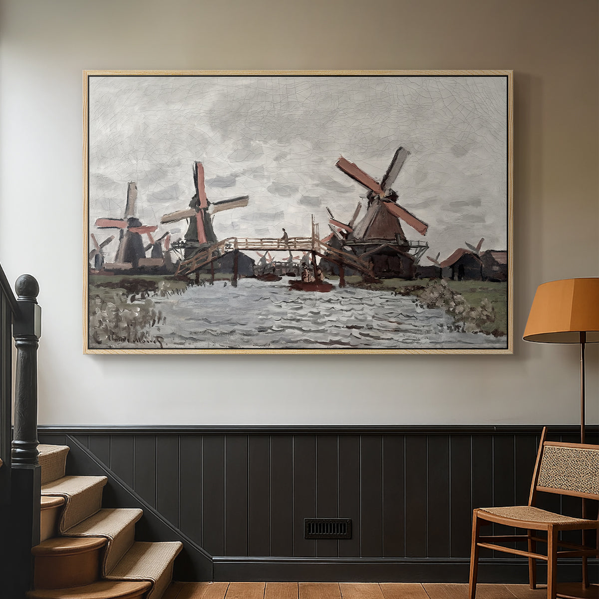Natural wood floater framed canvas featuring a landscape featuring windmills and low horizon sky, displayed in a hallway near a staircase.