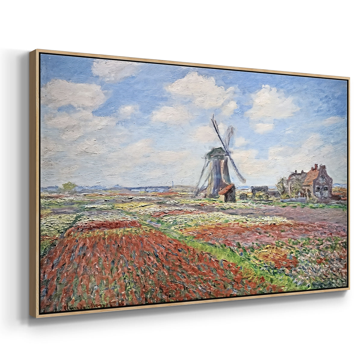 Angled view of Tulip Fields with the Rijnsburg Windmill, 1886 by Claude Monet in a natural wood floater framed canvas.