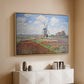 Natural wood floater framed canvas of Tulip Fields with the Rijnsburg Windmill, 1886 by Claude Monet, featuring a vibrant agricultural landscape with flowers and windmill above a console cabinet in a minimalist entryway.