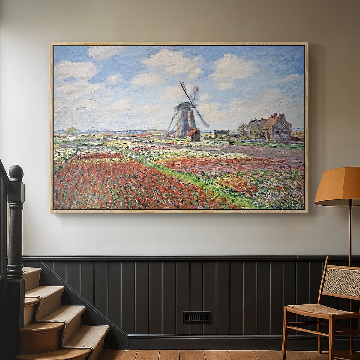 Natural wood floater framed canvas featuring a rural scene with patterned rows of flowers and windmill, displayed in a hallway near a staircase.
