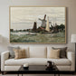 Windmill at Zaandam, 1871 by Claude Monet displayed in a natural wood floater framed canvas above a sofa in a clean living room.