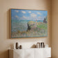 Natural wood floater framed canvas of The Cliff Walk at Pourville, 1882 by Claude Monet, featuring an impressionist seaside landscape with people strolling above water above a console cabinet in a minimalist entryway.