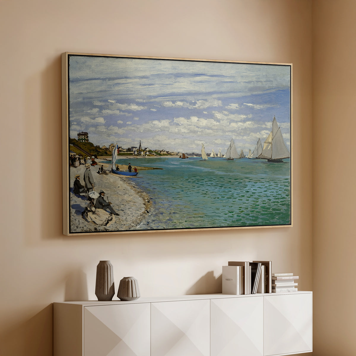 Natural wood floater framed canvas of Regatta at Sainte-Adresse, 1867 by Claude Monet, featuring a lively regatta scene with boats and people on beach above a console cabinet in a minimalist entryway.