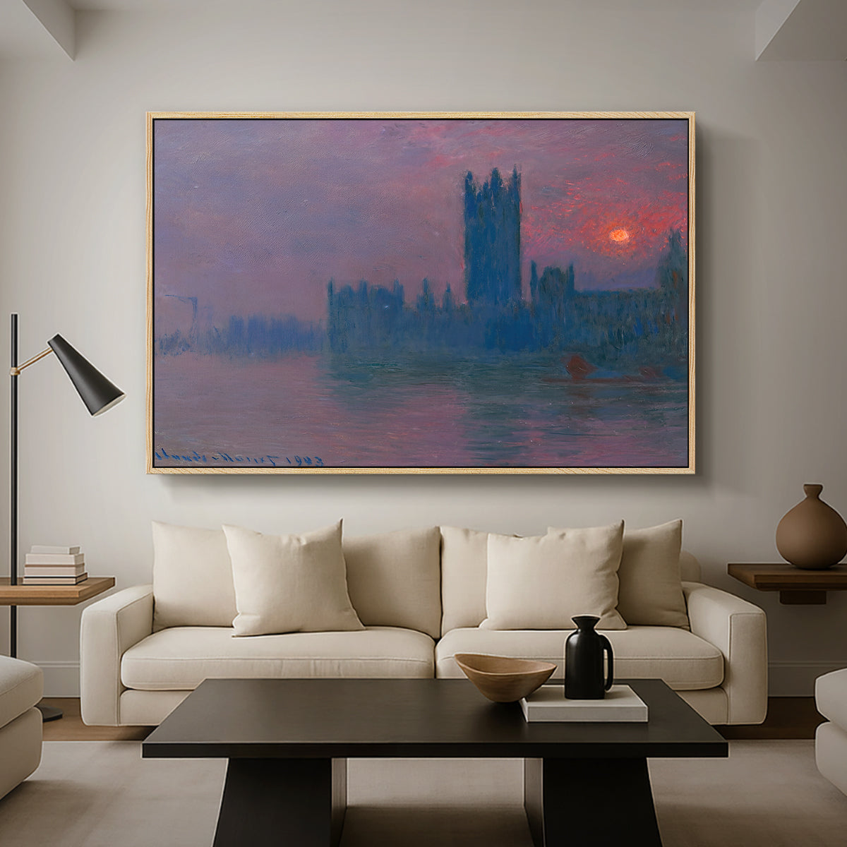 The Houses of Parliament, Sunset, 1903 by Claude Monet as a natural wood floater framed canvas featuring a silhouette of Parliament buildings against glowing sunset across river, displayed above a sofa in a modern living room.