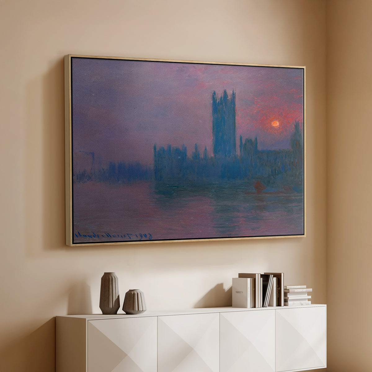 Natural wood floater framed canvas of The Houses of Parliament, Sunset, 1903 by Claude Monet, featuring an impressionist cityscape with warm sunset light over water above a console cabinet in a minimalist entryway.