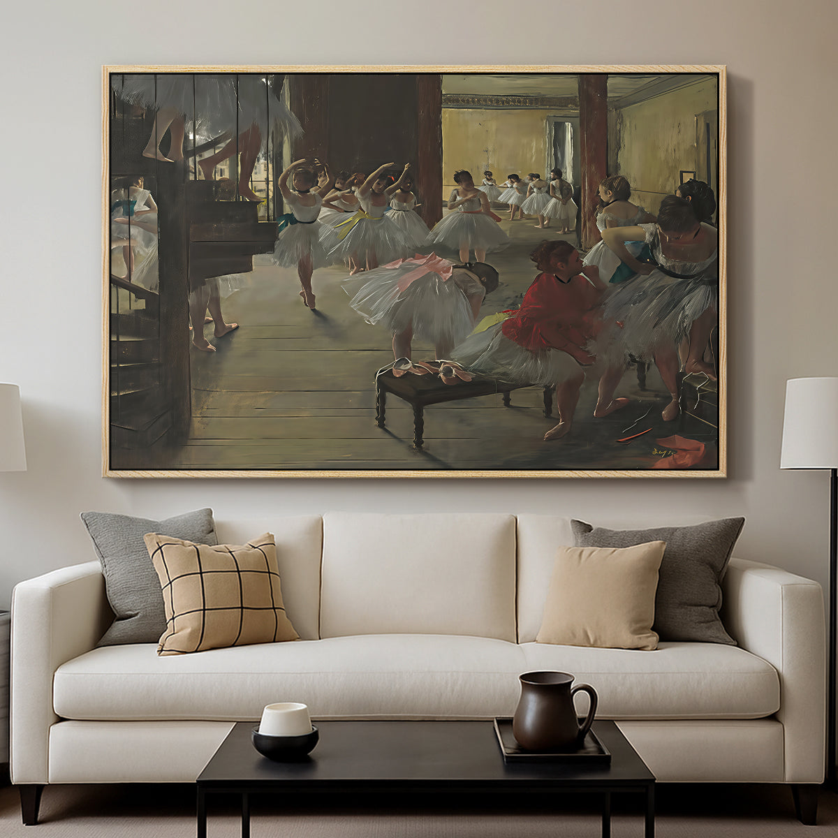 The Dance Class, c. 1873 by Edgar Degas displayed in a natural wood floater framed canvas above a sofa in a clean living room.