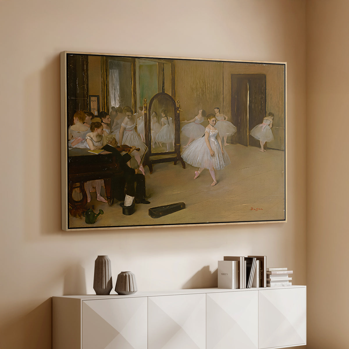 Natural wood floater framed canvas of The Dancing Class, c. 1870 by Edgar Degas, featuring a rehearsal scene with ballerinas in tutus arranged in studio above a console cabinet in a minimalist entryway.