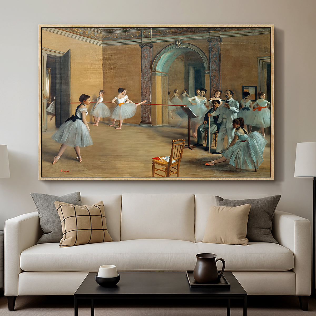 The Dance Foyer at the Opera on the Rue Le Peletier, 1872 by Edgar Degas displayed in a natural wood floater framed canvas above a sofa in a clean living room.