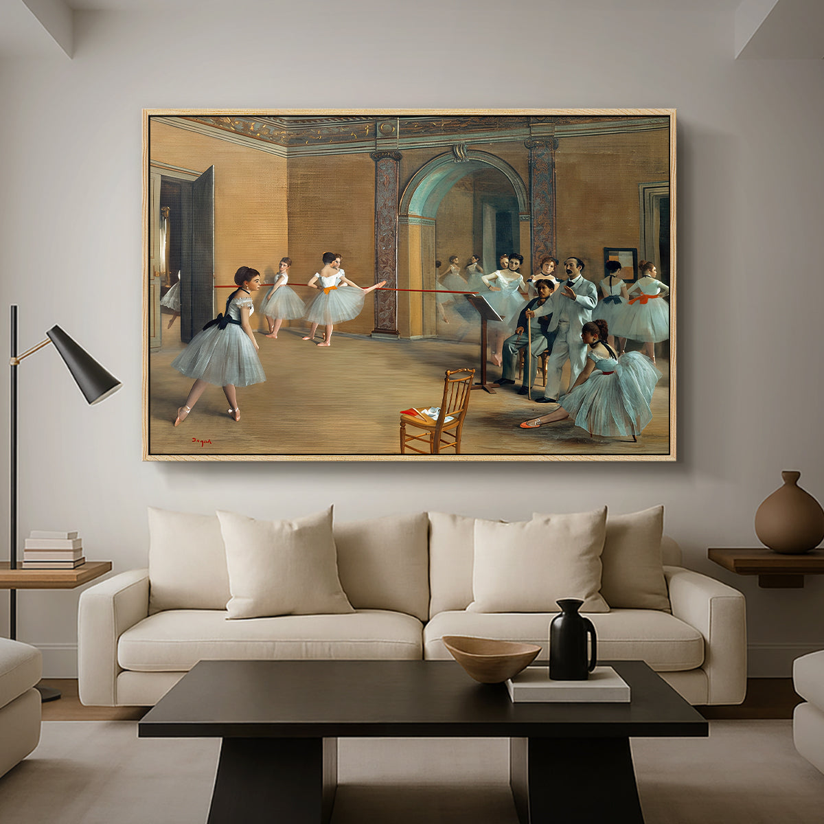 The Dance Foyer at the Opera on the Rue Le Peletier, 1872 by Edgar Degas as a natural wood floater framed canvas featuring ballet dancers gathered in rehearsal hall with mirrors and columns, displayed above a sofa in a modern living room.