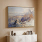 Natural wood floater framed canvas of Col du Géant, 1903 by Edward Theodore Compton, featuring a high mountain landscape featuring dramatic ridges and glacier terrain above a console cabinet in a minimalist entryway.