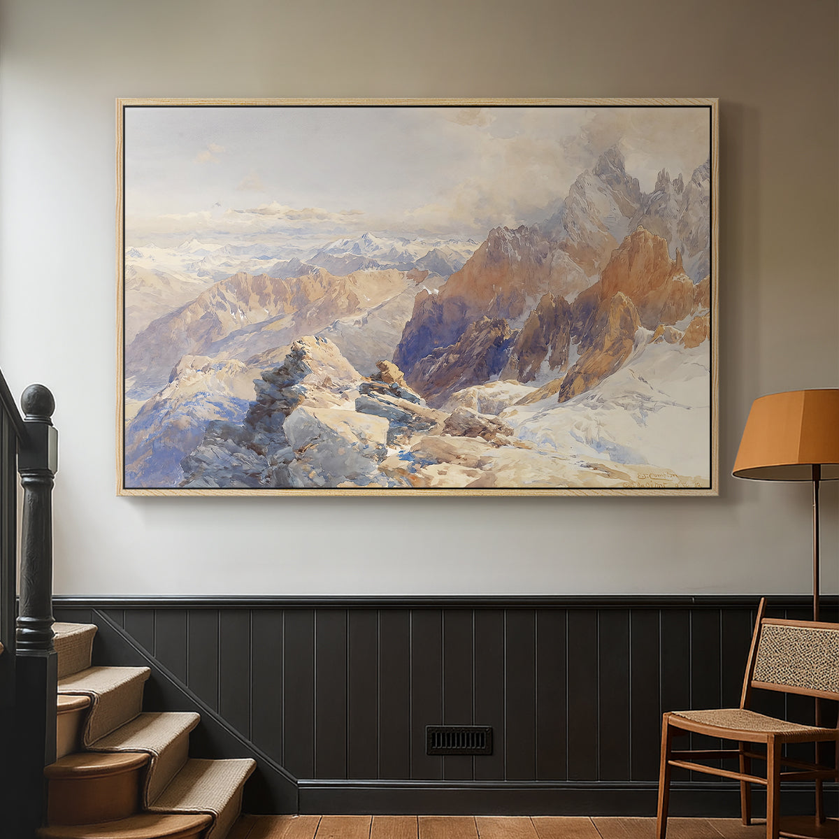 Natural wood floater framed canvas featuring a rugged mountain pass scene with distant peaks, displayed in a hallway near a staircase.