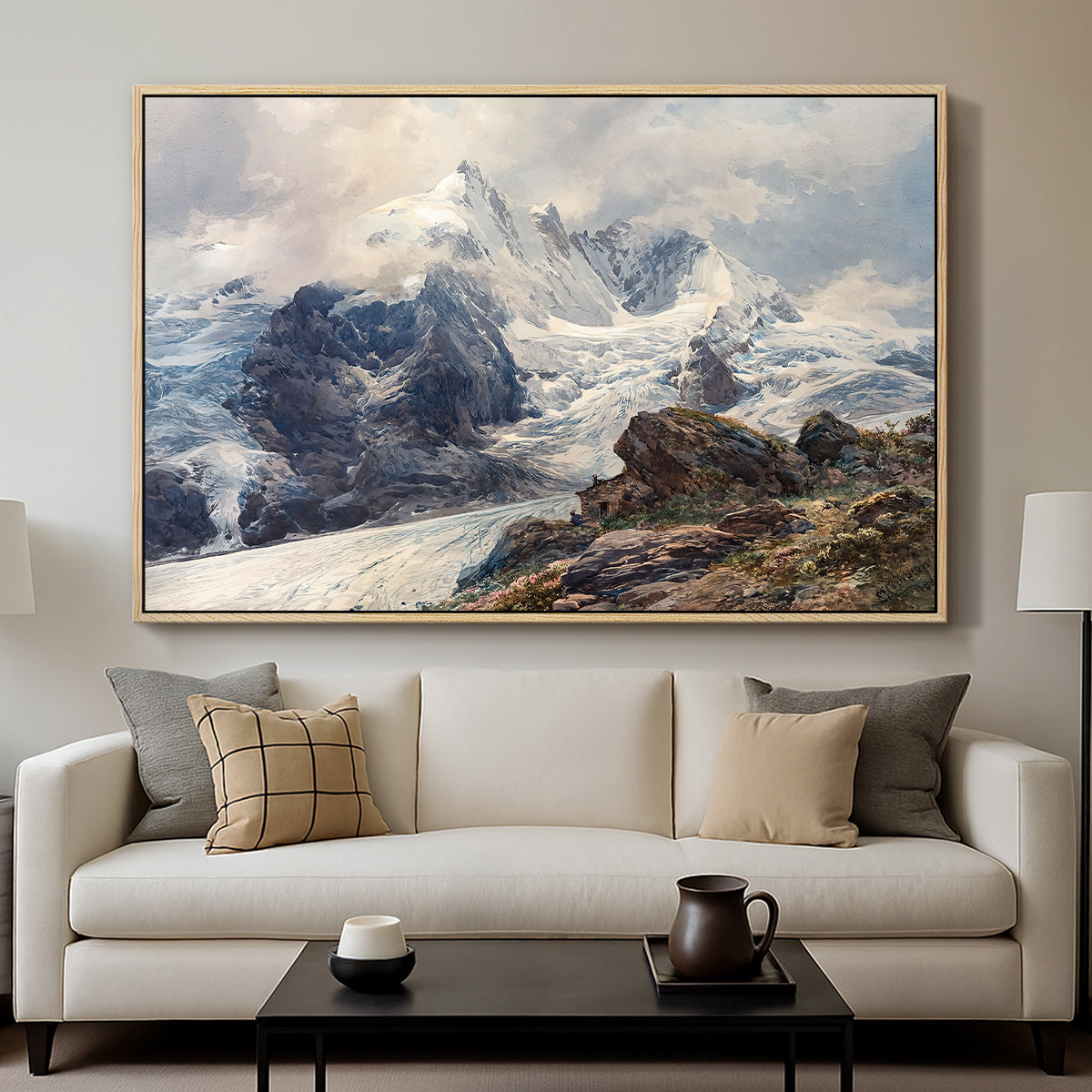 The Grossglockner, 1880 by Edward Theodore Compton displayed in a natural wood floater framed canvas above a sofa in a clean living room.