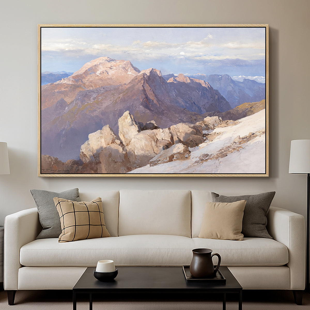 Hoher Göll from Watzmann-Hocheck, 1919 by Edward Theodore Compton displayed in a natural wood floater framed canvas above a sofa in a clean living room.