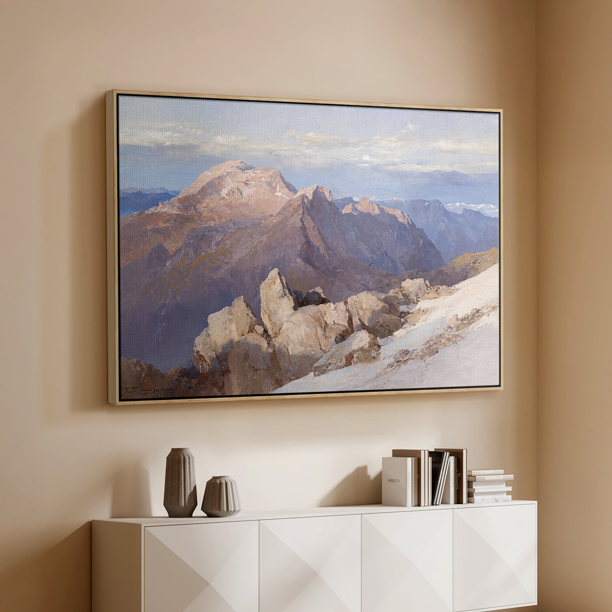 Natural wood floater framed canvas of Hoher Göll from Watzmann-Hocheck, 1919 by Edward Theodore Compton, featuring an alpine panorama showing layered peaks and valleys above a console cabinet in a minimalist entryway.