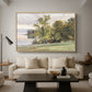 Landscape at Lake Starnberg, 1890 by Edward Theodore Compton as a natural wood floater framed canvas featuring a lakeside landscape with calm water and trees along shoreline, displayed above a sofa in a modern living room.