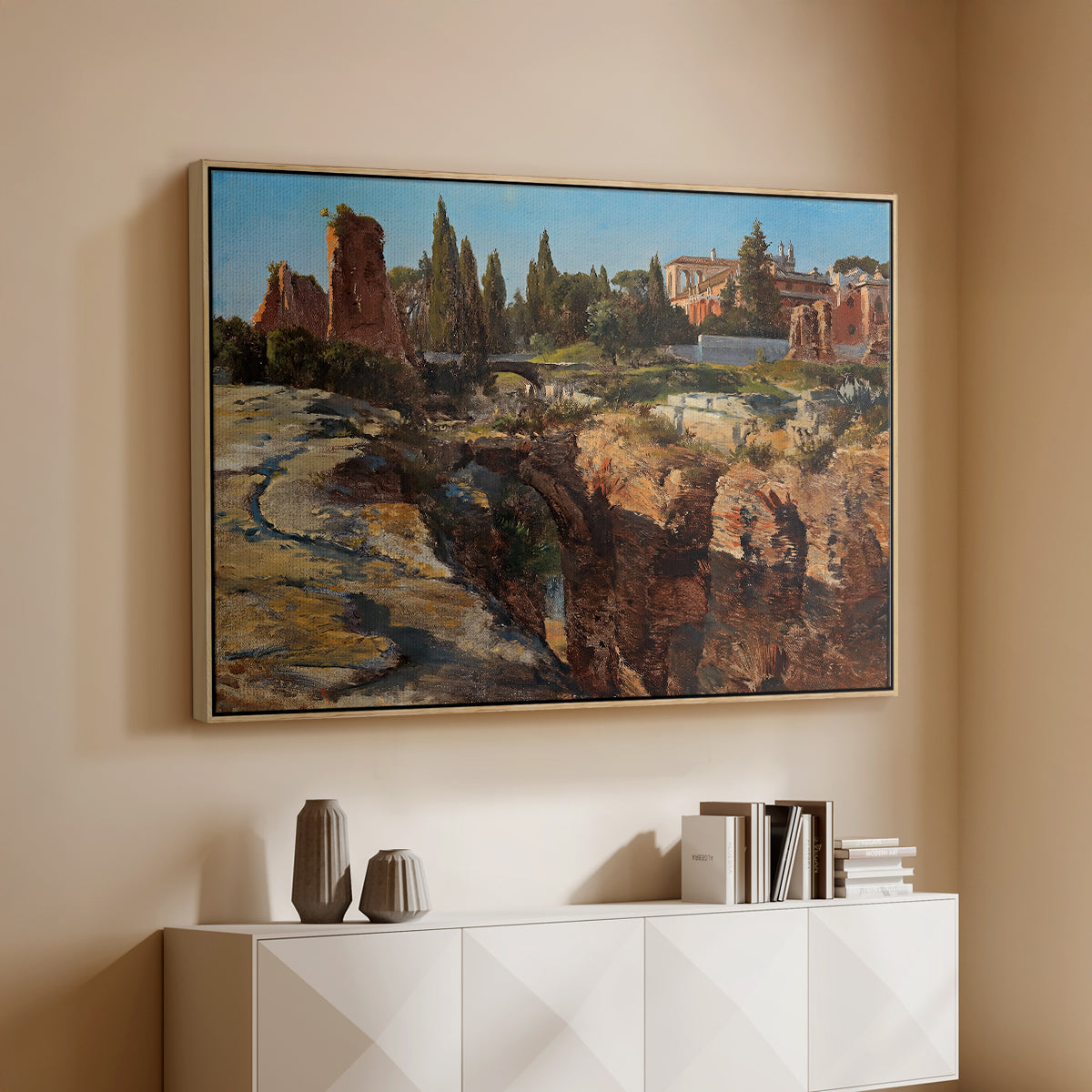 Natural wood floater framed canvas of Palatine in Rome, c. 1921 by Edward Theodore Compton, featuring an architectural scene of ancient structures in sunlit environment above a console cabinet in a minimalist entryway.