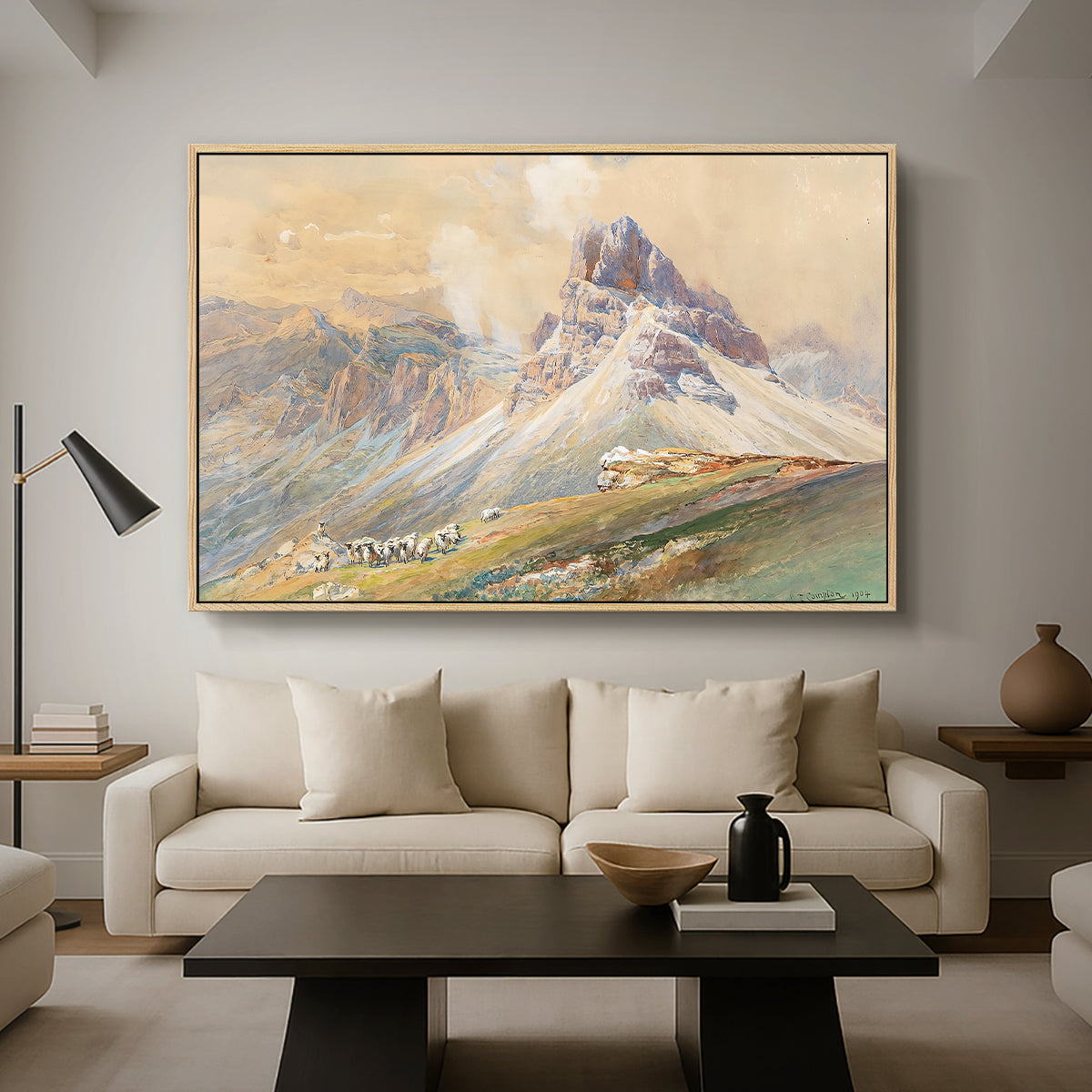 From the Dolomites, 1904 by Edward Theodore Compton as a natural wood floater framed canvas featuring dramatic Dolomite mountain peaks rising above rugged terrain, displayed above a sofa in a modern living room.