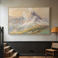 Natural wood floater framed canvas featuring a realistic mountain view with strong geological forms, displayed in a hallway near a staircase.