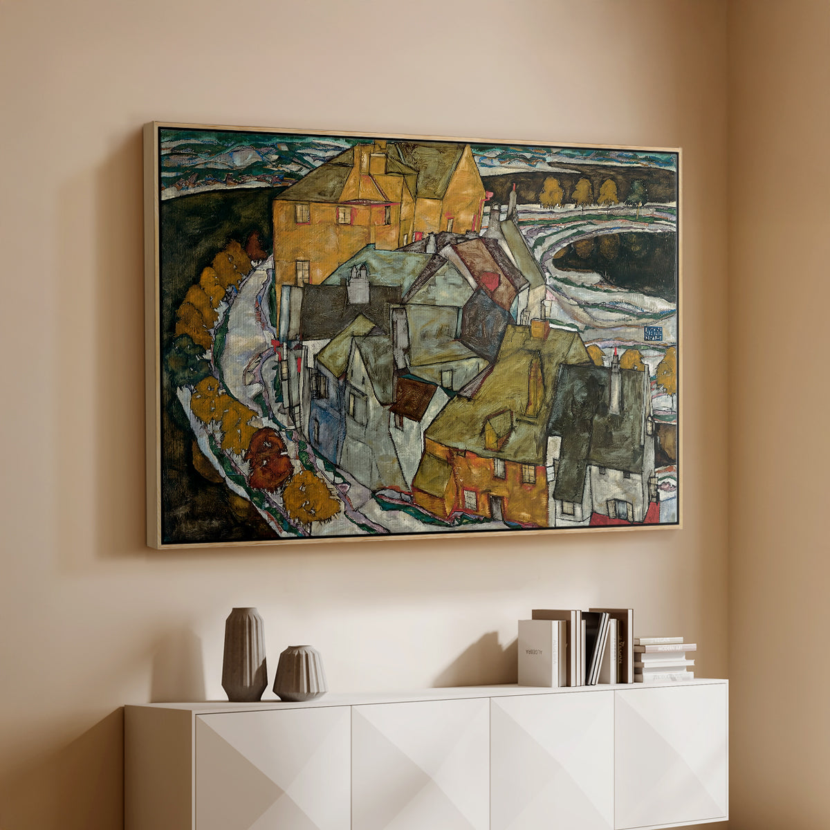 Natural wood floater framed canvas of Crescent of Houses II (Island Town), 1915 by Egon Schiele, featuring a stylized townscape with clustered buildings and bold outlines above a console cabinet in a minimalist entryway.