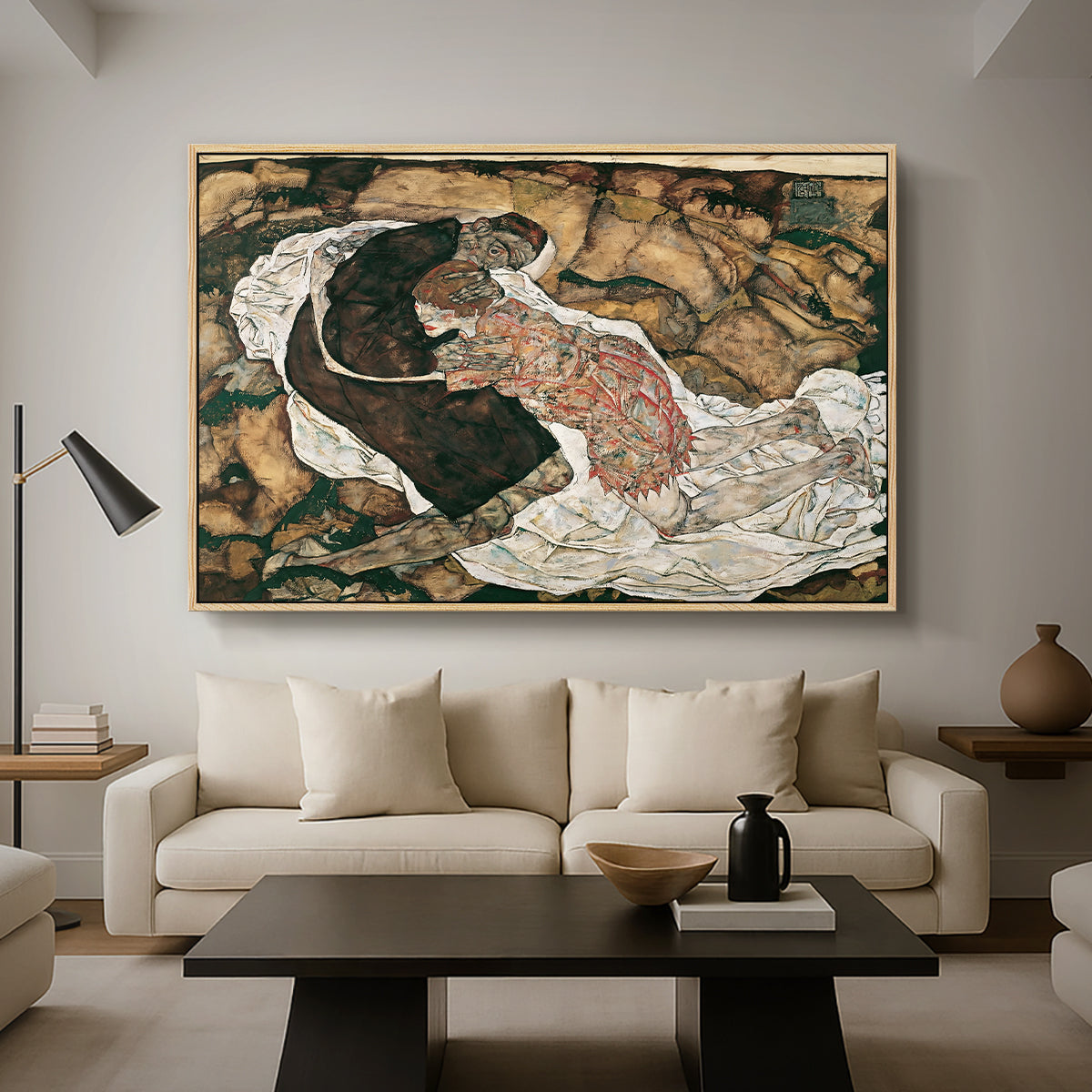 Death and the Maiden, 1915 by Egon Schiele as a natural wood floater framed canvas featuring intertwined figures representing death and woman in emotional embrace, displayed above a sofa in a modern living room.