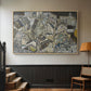 Natural wood floater framed canvas featuring a stylized urban composition with geometric structures and muted tones, displayed in a hallway near a staircase.